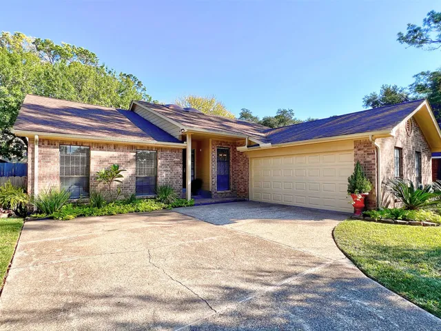 a front view of a house with a yard and a garage