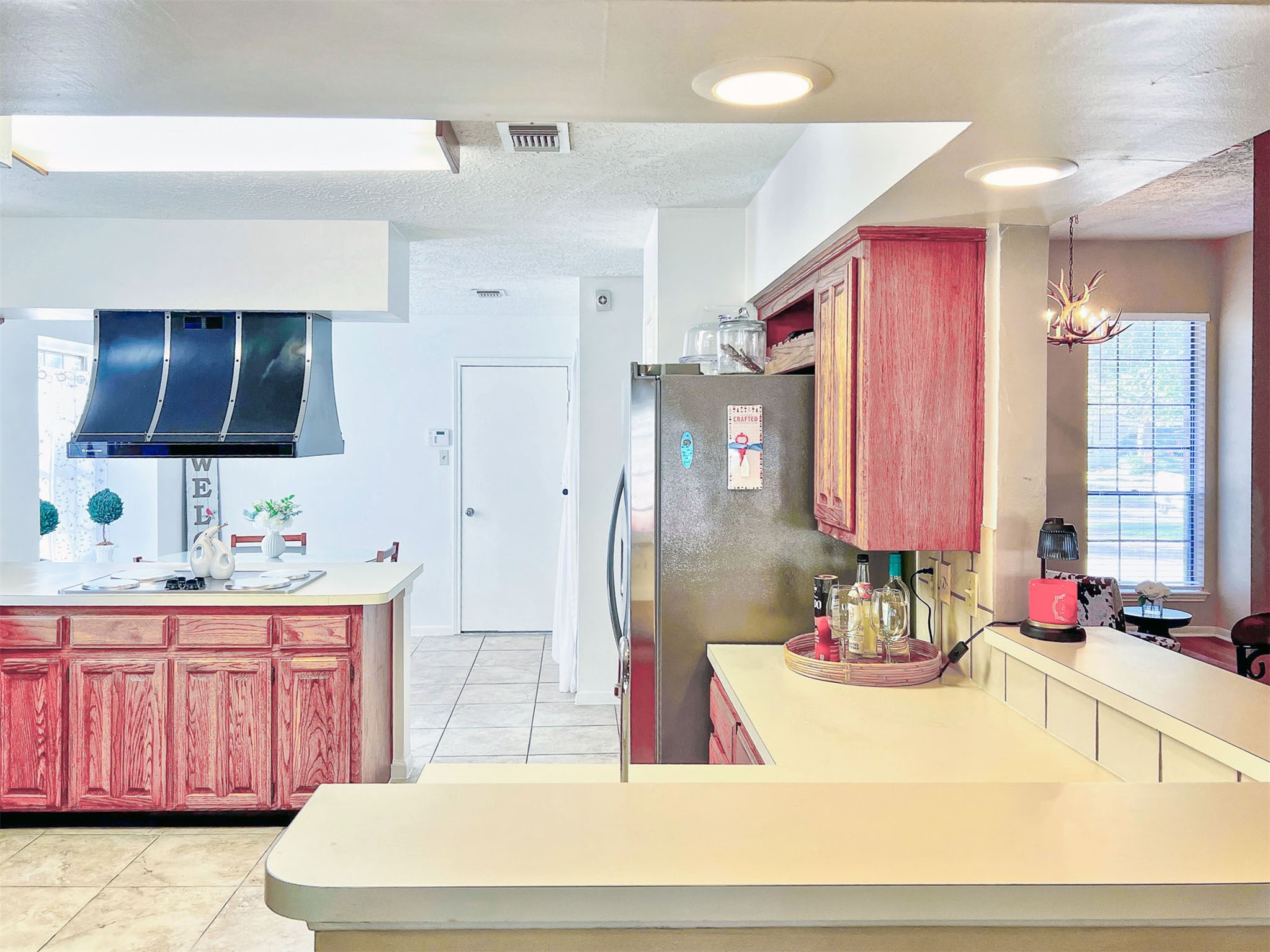 12510 Millvan Drive Houston, TX 77070 - Photo 23 of 46 a room with stainless steel appliances kitchen island granite countertop a sink a stove and a wooden cabinets