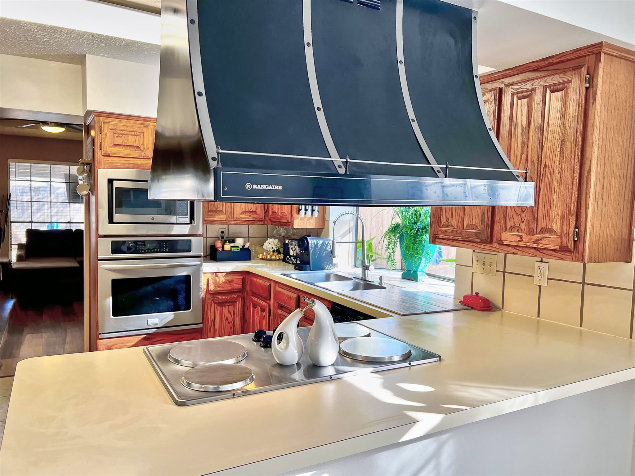 12510 Millvan Drive Houston, TX 77070 - Photo 26 of 46 a kitchen with sink a stove and a microwave
