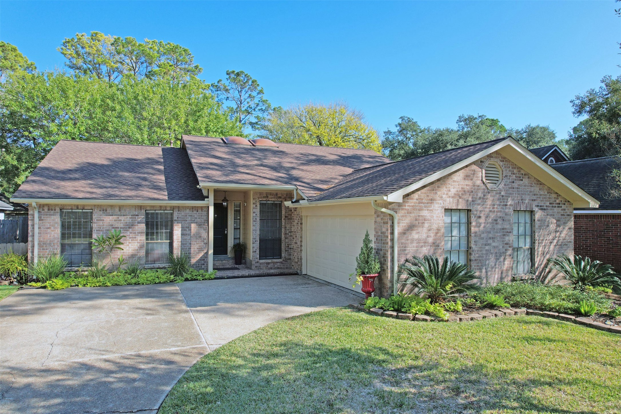 12510 Millvan Drive Houston, TX 77070 - Photo 32 of 46 a front view of a house with a yard and potted plants