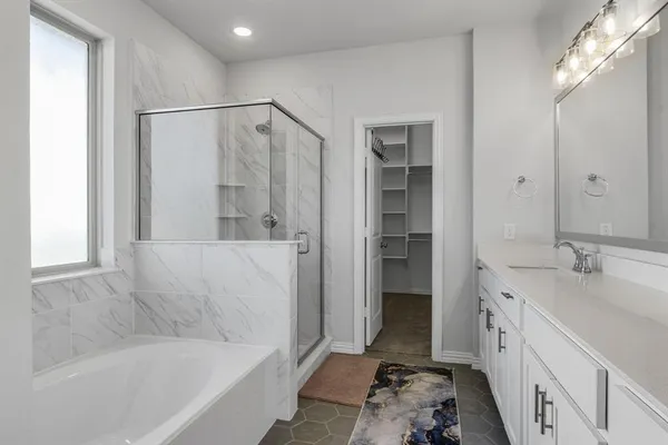 a bathroom with a tub sink and mirror