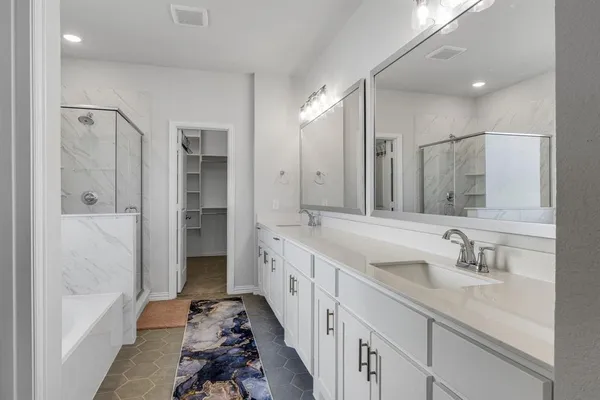 a spacious bathroom with a shower sink double and mirror