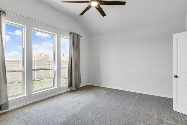 a view of room with window and ceiling fan
