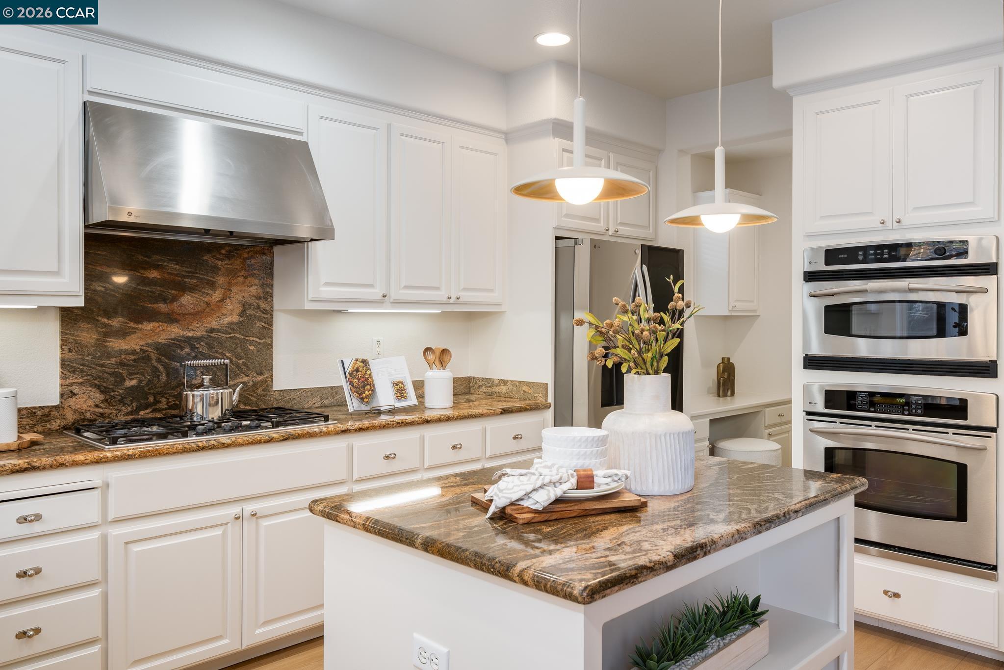 3138 Ashbrook Lane San Ramon, CA 94582 - Photo 11 of 27 a kitchen with stainless steel appliances granite countertop a sink a stove and a wooden cabinets