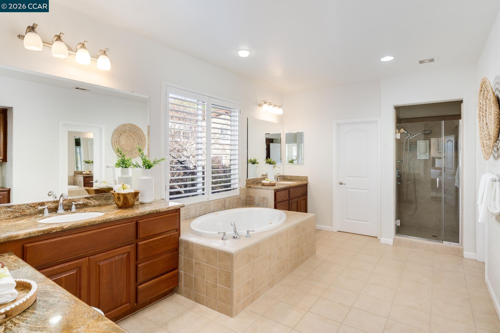 3138 Ashbrook Lane San Ramon, CA 94582 - Photo 17 of 27 a bathroom with a tub sink and mirror