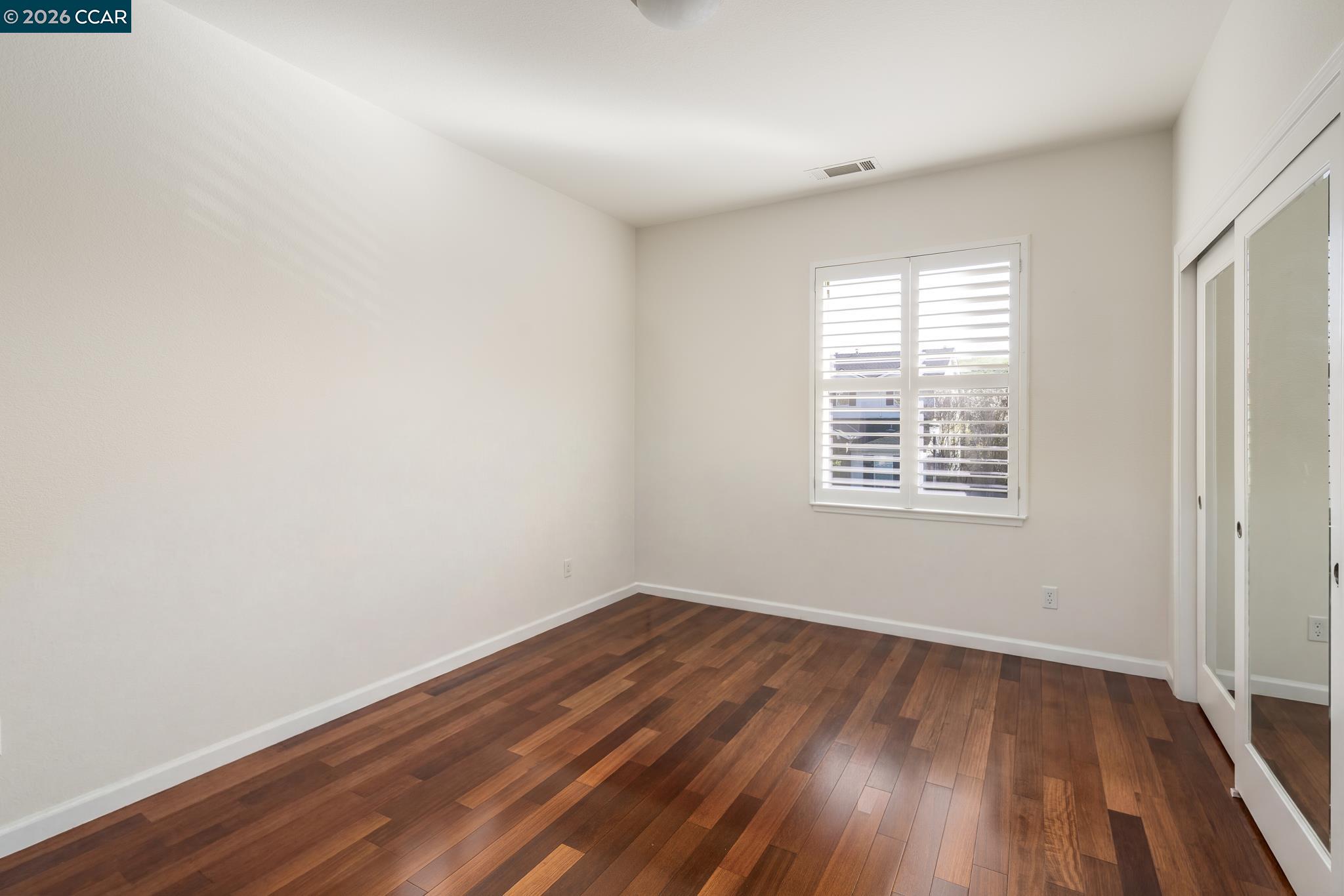 3138 Ashbrook Lane San Ramon, CA 94582 - Photo 20 of 27 an empty room with wooden floor and windows
