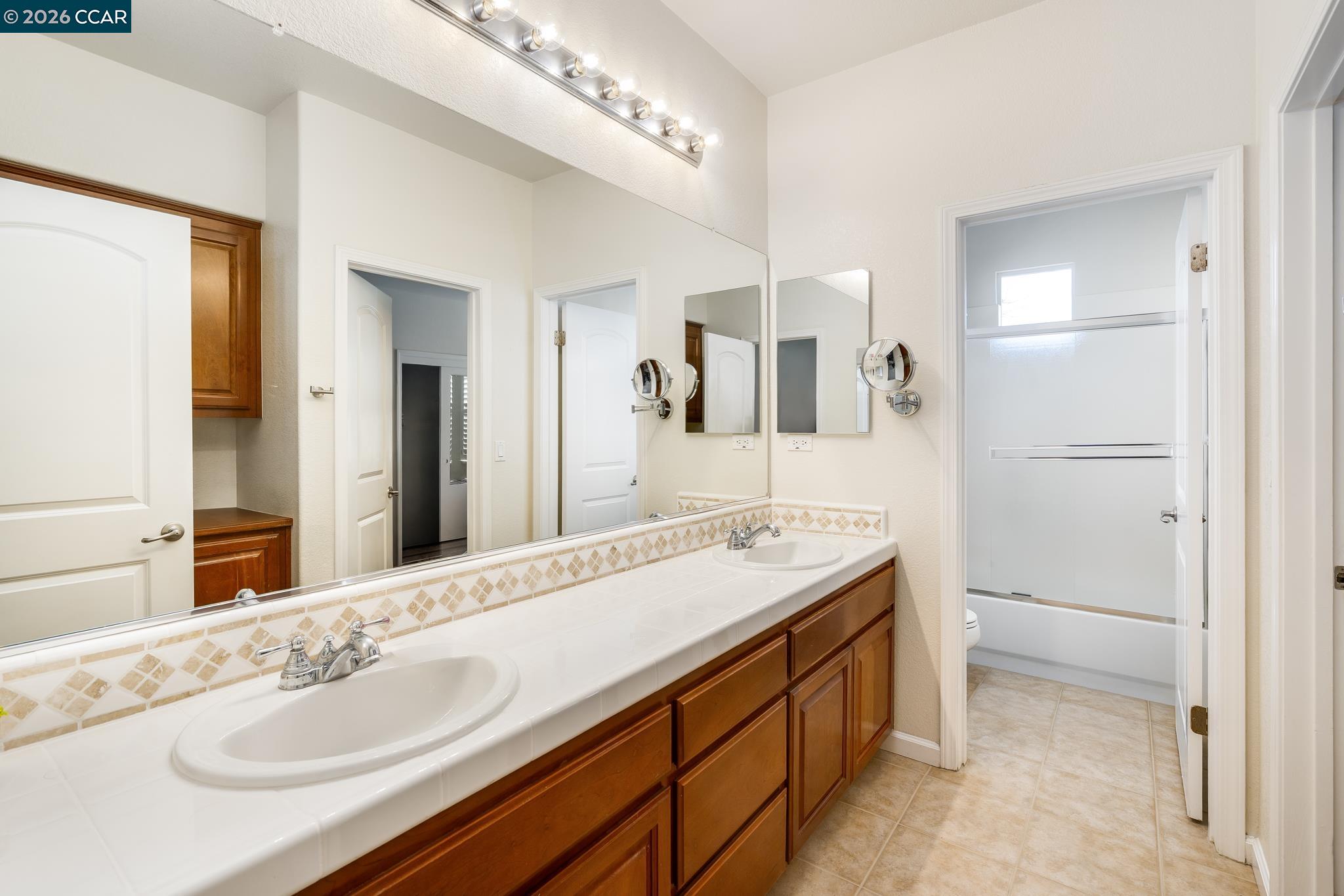 3138 Ashbrook Lane San Ramon, CA 94582 - Photo 21 of 27 a spacious bathroom with a granite countertop sink and a mirror