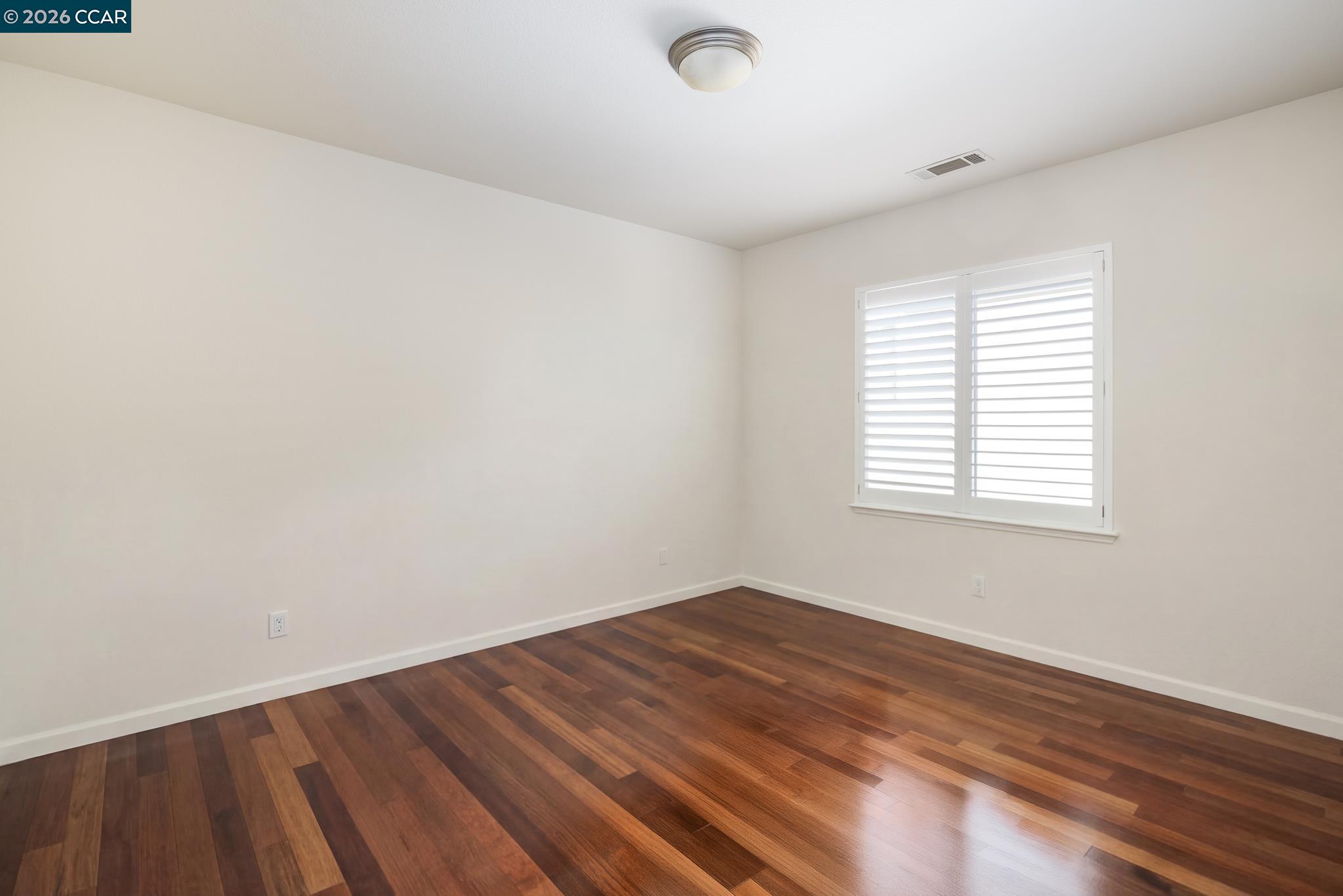 3138 Ashbrook Lane San Ramon, CA 94582 - Photo 22 of 27 an empty room with wooden floor and windows