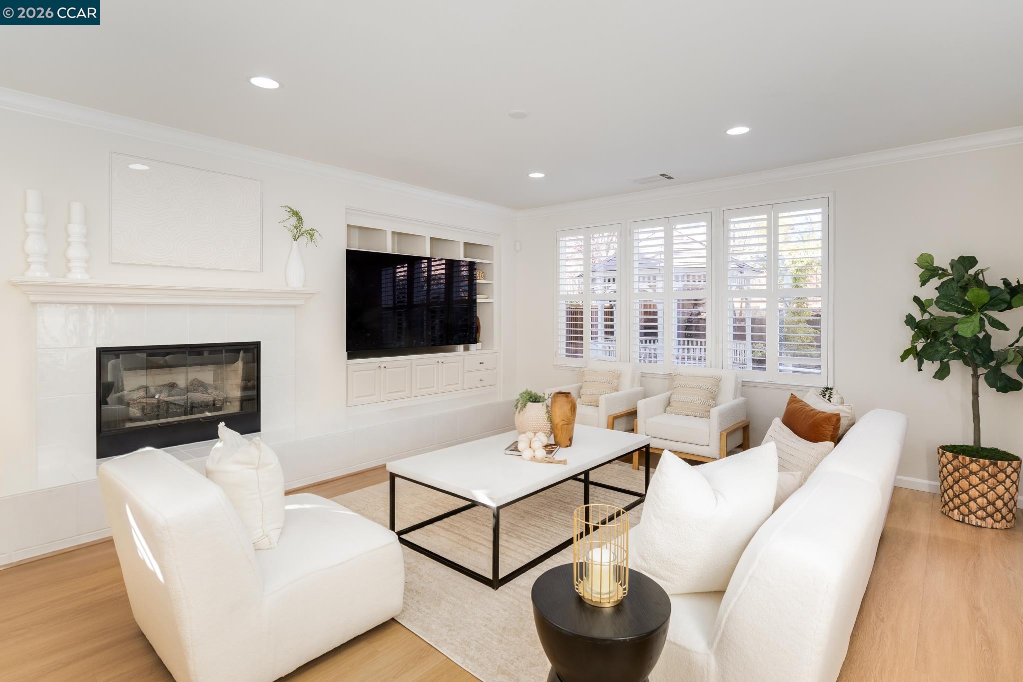3138 Ashbrook Lane San Ramon, CA 94582 - Photo 4 of 27 a living room with furniture a flat screen tv and a fireplace