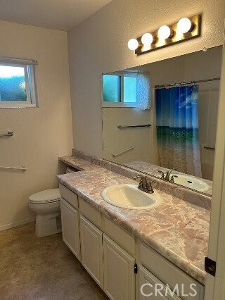 1743 Northview Place Paso Robles, CA 93446 - Photo 9 of 26 a bathroom with a granite countertop sink a toilet and mirror