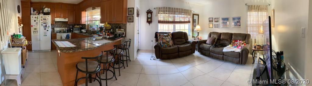 6857 Southwest 158th Pass Miami, FL 33193 - Photo 11 of 41 a living room with furniture and a floor to ceiling window