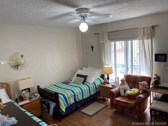 6857 Southwest 158th Pass Miami, FL 33193 - Photo 15 of 41 a bedroom with a bed window and couch