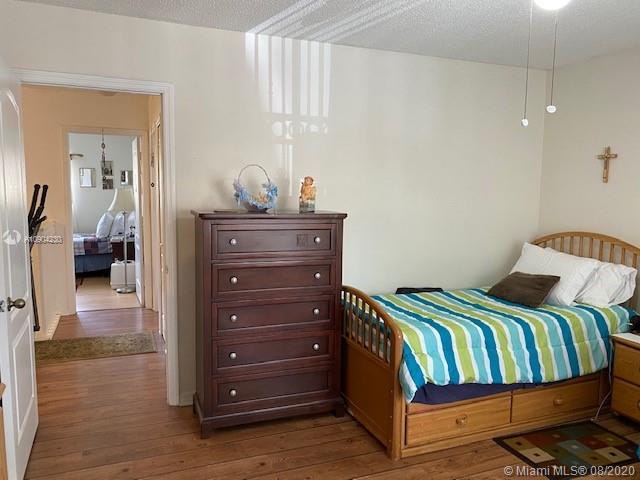 6857 Southwest 158th Pass Miami, FL 33193 - Photo 17 of 41 a bedroom with a bed and wooden floor