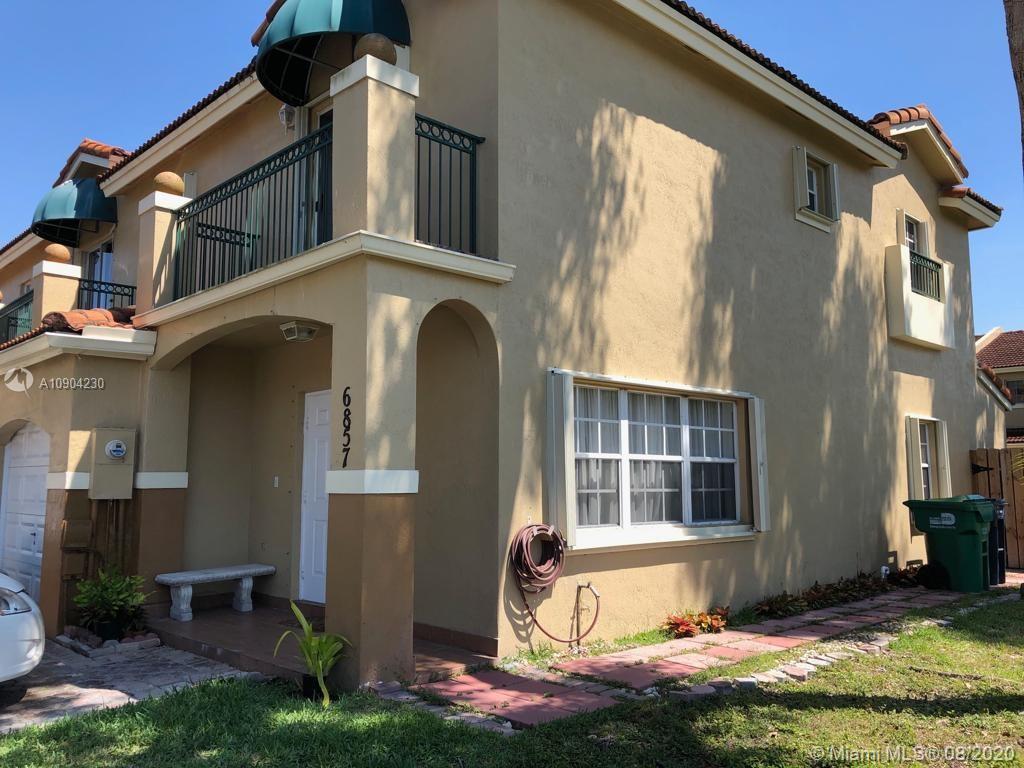 6857 Southwest 158th Pass Miami, FL 33193 - Photo 2 of 41 a front view of a house with a yard