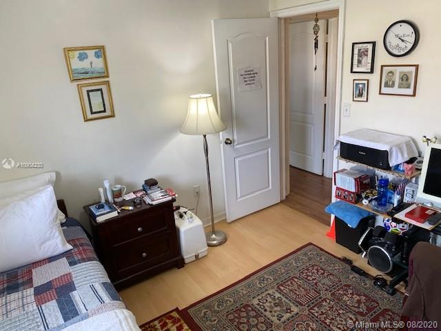 6857 Southwest 158th Pass Miami, FL 33193 - Photo 21 of 41 a bedroom with a bed and wooden floor