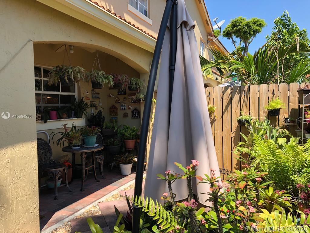 6857 Southwest 158th Pass Miami, FL 33193 - Photo 24 of 41 a dining room with a table and chairs and potted plants