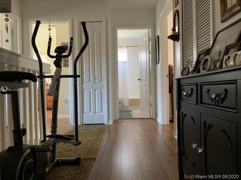6857 Southwest 158th Pass Miami, FL 33193 - Photo 30 of 41 a view of a hallway with wooden floor and entryway