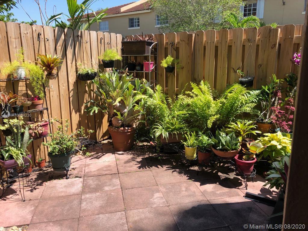 6857 Southwest 158th Pass Miami, FL 33193 - Photo 41 of 41 a bunch of flowers with wooden fence