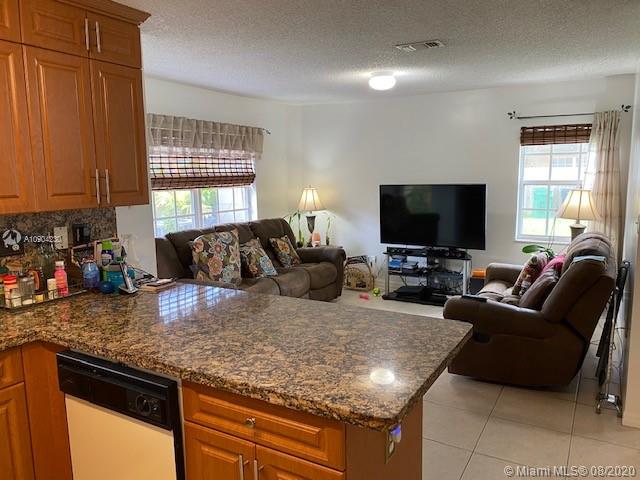 6857 Southwest 158th Pass Miami, FL 33193 - Photo 8 of 41 a living room with granite countertop furniture and a flat screen tv