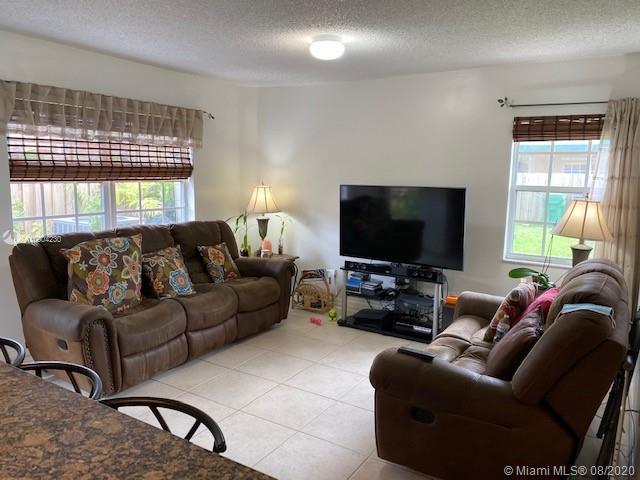 6857 Southwest 158th Pass Miami, FL 33193 - Photo 10 of 41 a living room with furniture and a flat screen tv