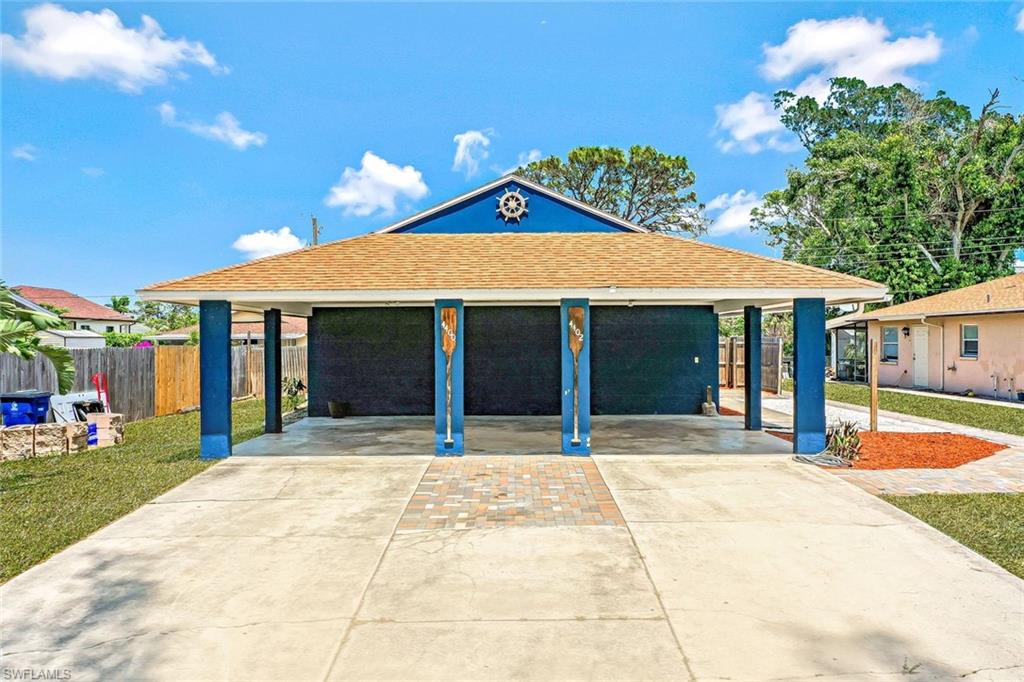 View of front of home featuring concrete driveway and a shingled roof
