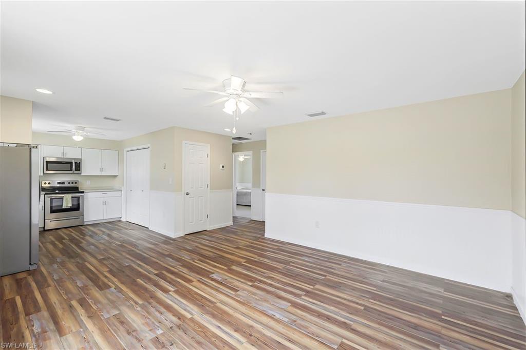 4402 Pine Lake Road Bonita Springs, FL 34134 - Photo 11 of 16 wooden floor in an empty room with a kitchen