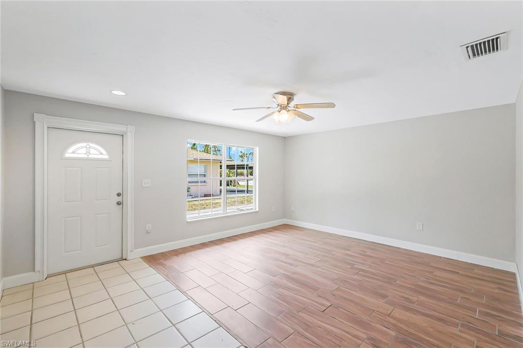 4402 Pine Lake Road Bonita Springs, FL 34134 - Photo 14 of 16 wooden floor in an empty room with a window