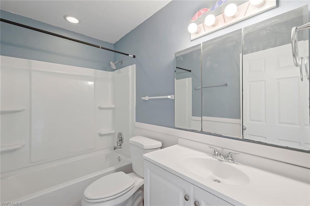 4402 Pine Lake Road Bonita Springs, FL 34134 - Photo 6 of 16 a bathroom with a sink a toilet and shower