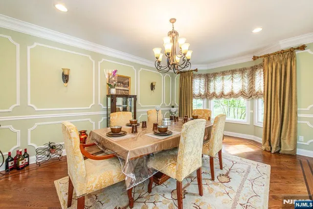 a view of a dining room with furniture wooden floor and chandelier