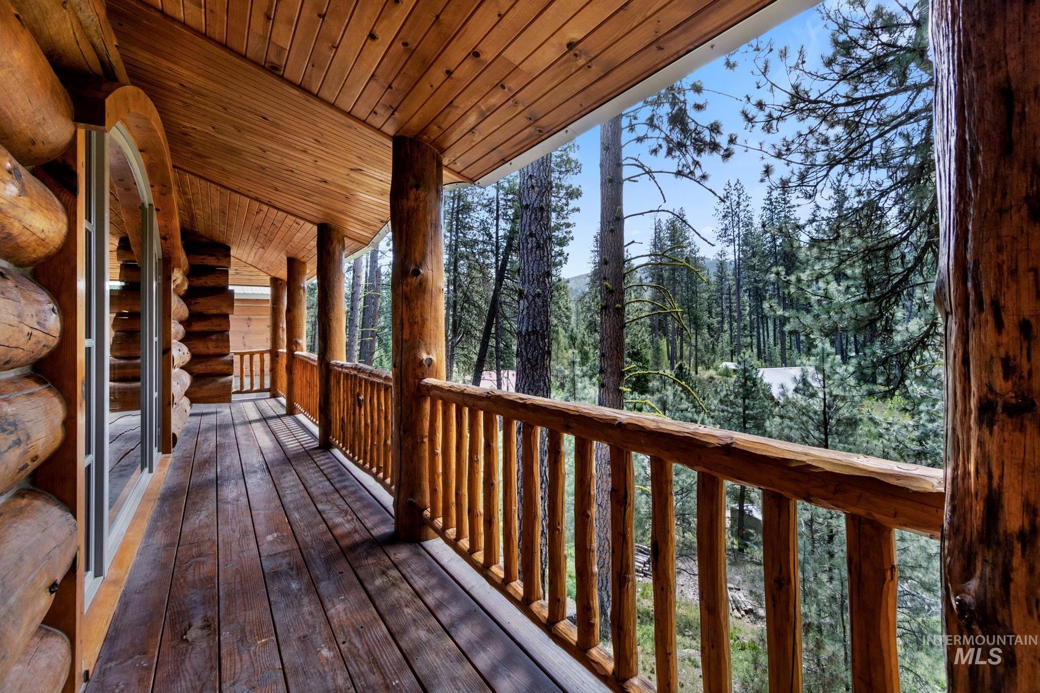 85 Pine Top Road Boise, ID 83716 - Photo 11 of 33 Expansive log home porch featuring a natural wood-finish floor and log railings