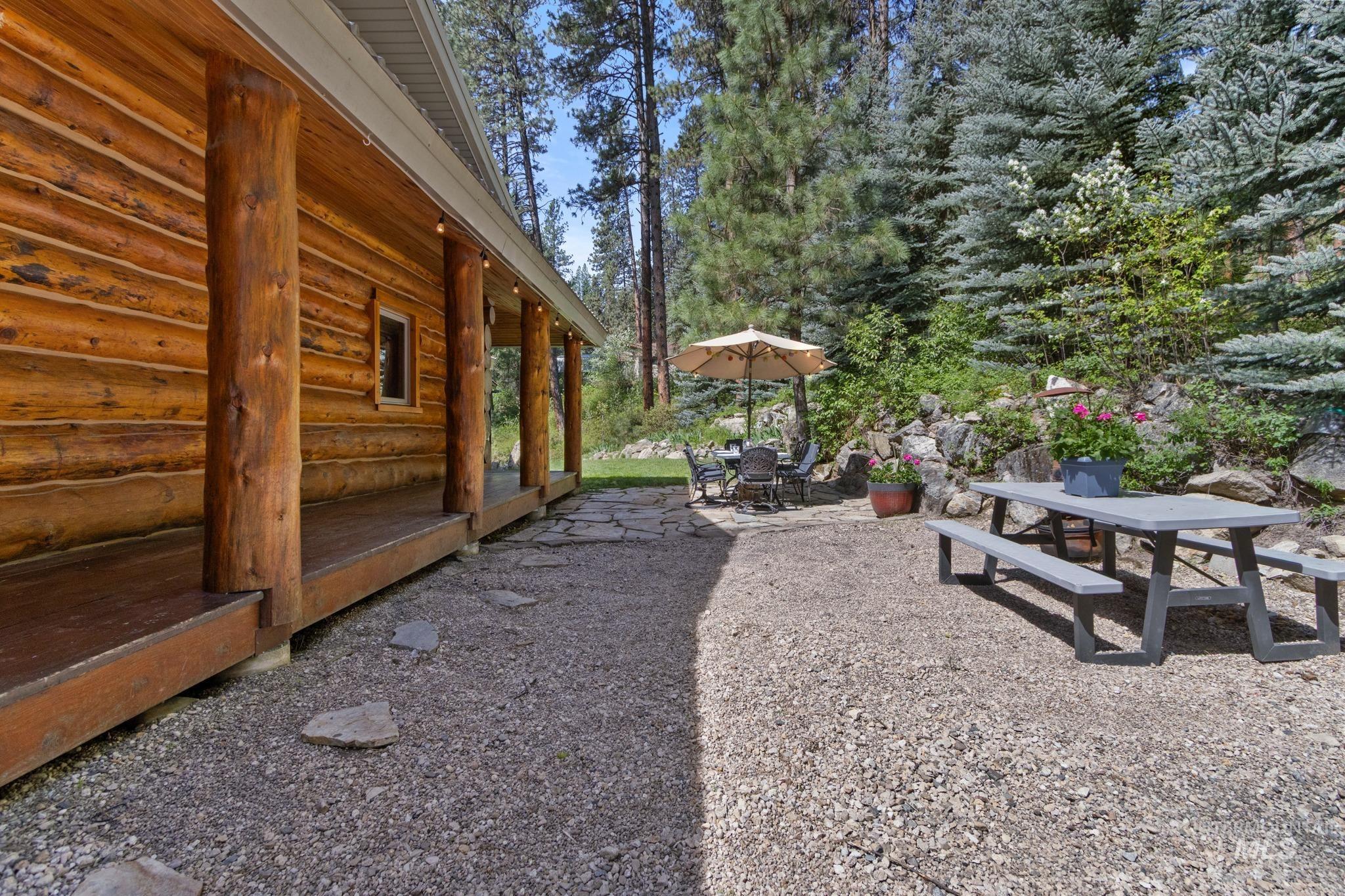 85 Pine Top Road Boise, ID 83716 - Photo 27 of 33 Log cabin exterior with a full-length covered porch