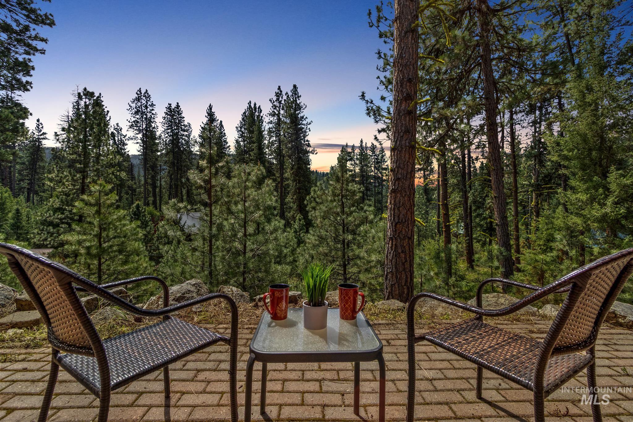 85 Pine Top Road Boise, ID 83716 - Photo 29 of 33 Brick paver patio surrounded by mature pine trees