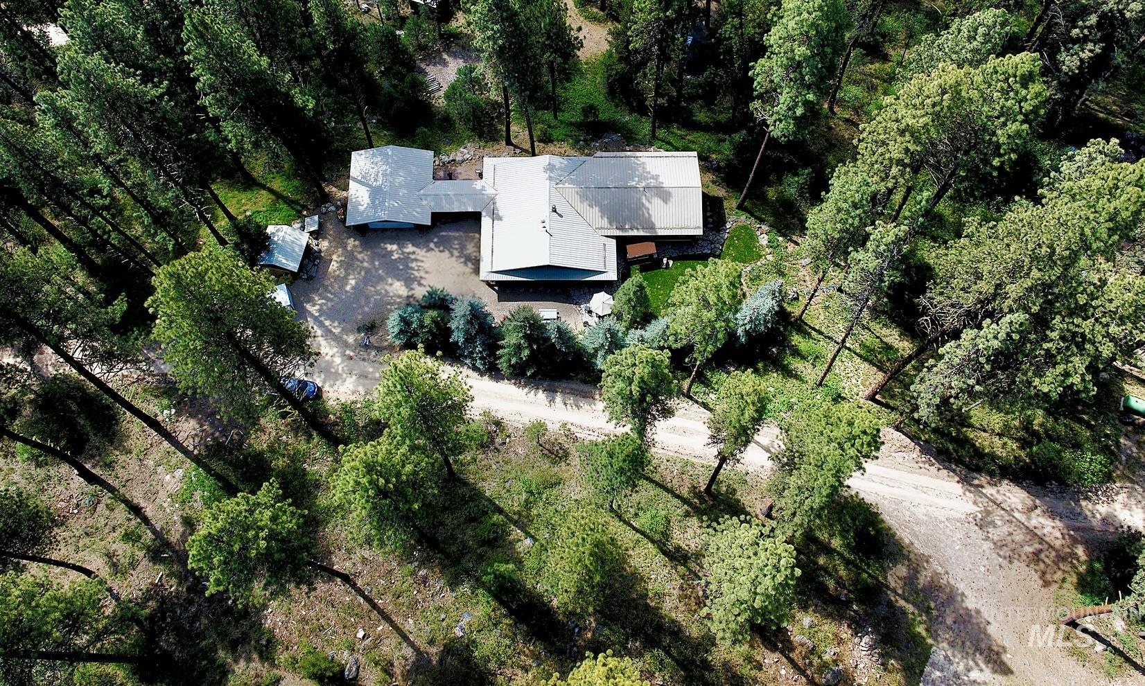 85 Pine Top Road Boise, ID 83716 - Photo 30 of 33 Expansive property featuring a residence with a metal roof, surrounded by mature trees