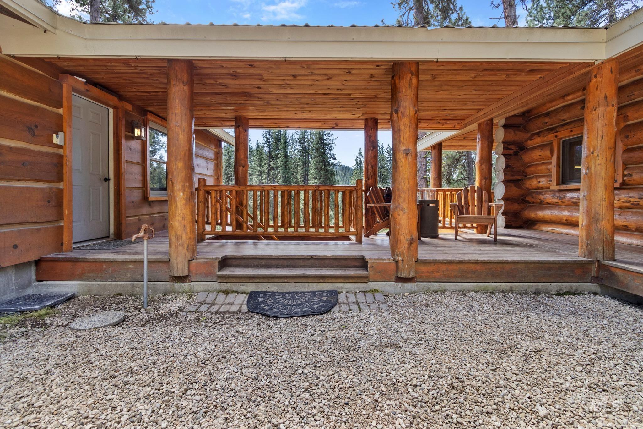 85 Pine Top Road Boise, ID 83716 - Photo 4 of 33 Expansive log home porch with natural wood posts, wood plank ceiling, and a wood railing