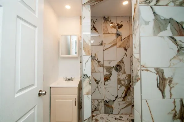 a bathroom with a bathtub and shower