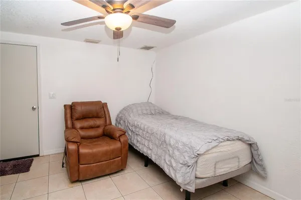 a bedroom with a bed and ceiling fan