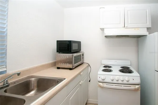 a kitchen with a stove and a microwave