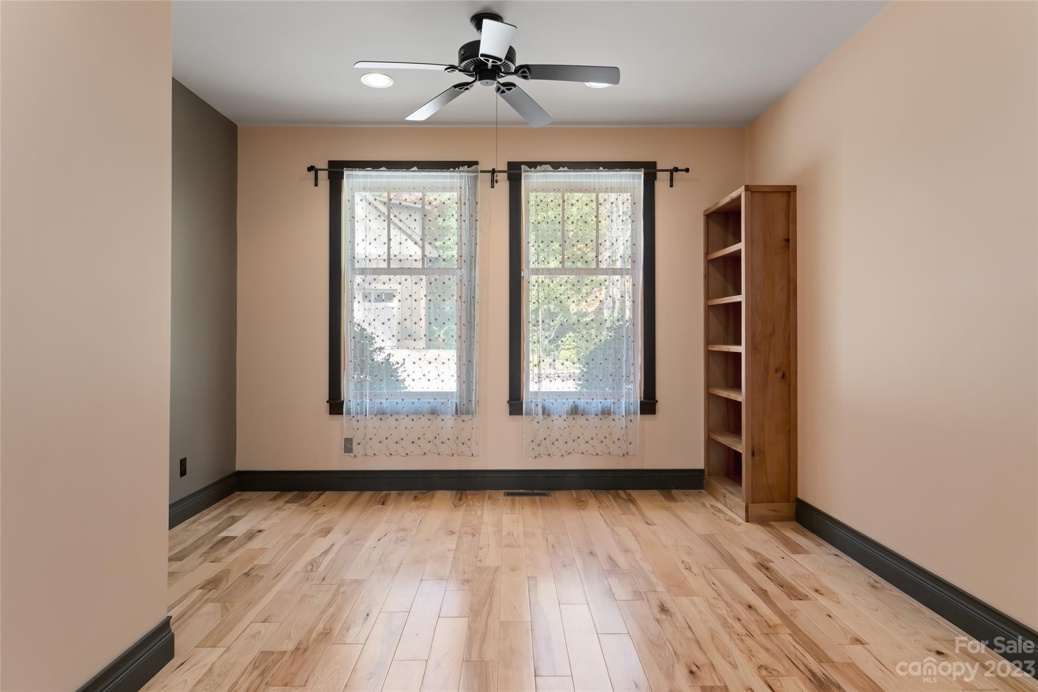 1025 Morgan Hill Road Black Mountain, NC 28711 - Photo 12 of 48 an empty room with wooden floor and windows