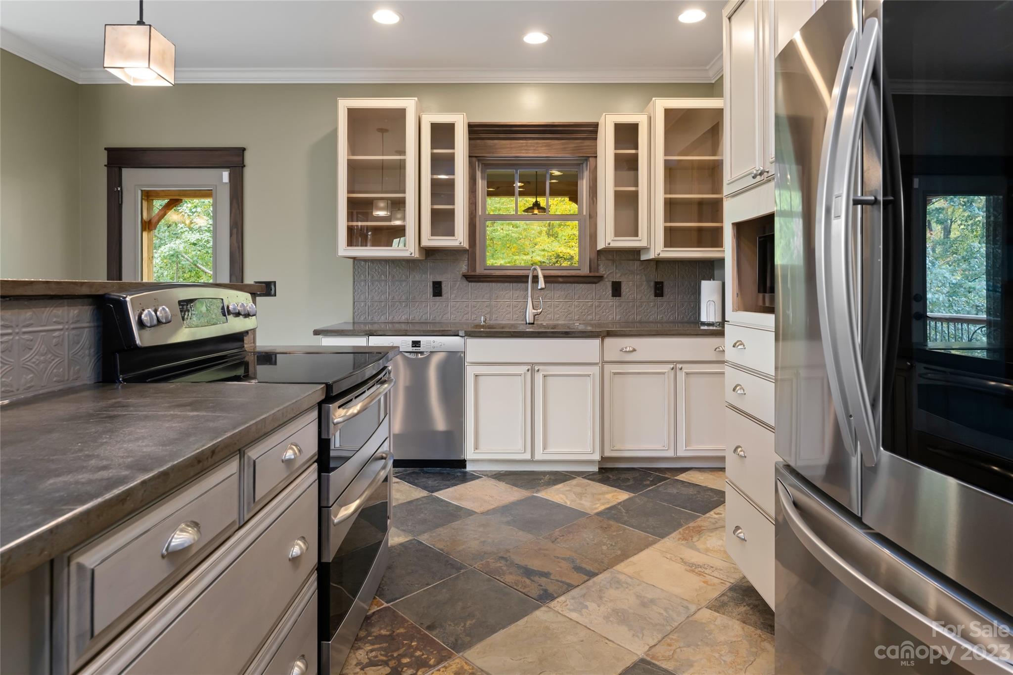 1025 Morgan Hill Road Black Mountain, NC 28711 - Photo 16 of 48 a kitchen with stainless steel appliances granite countertop a sink and a stove