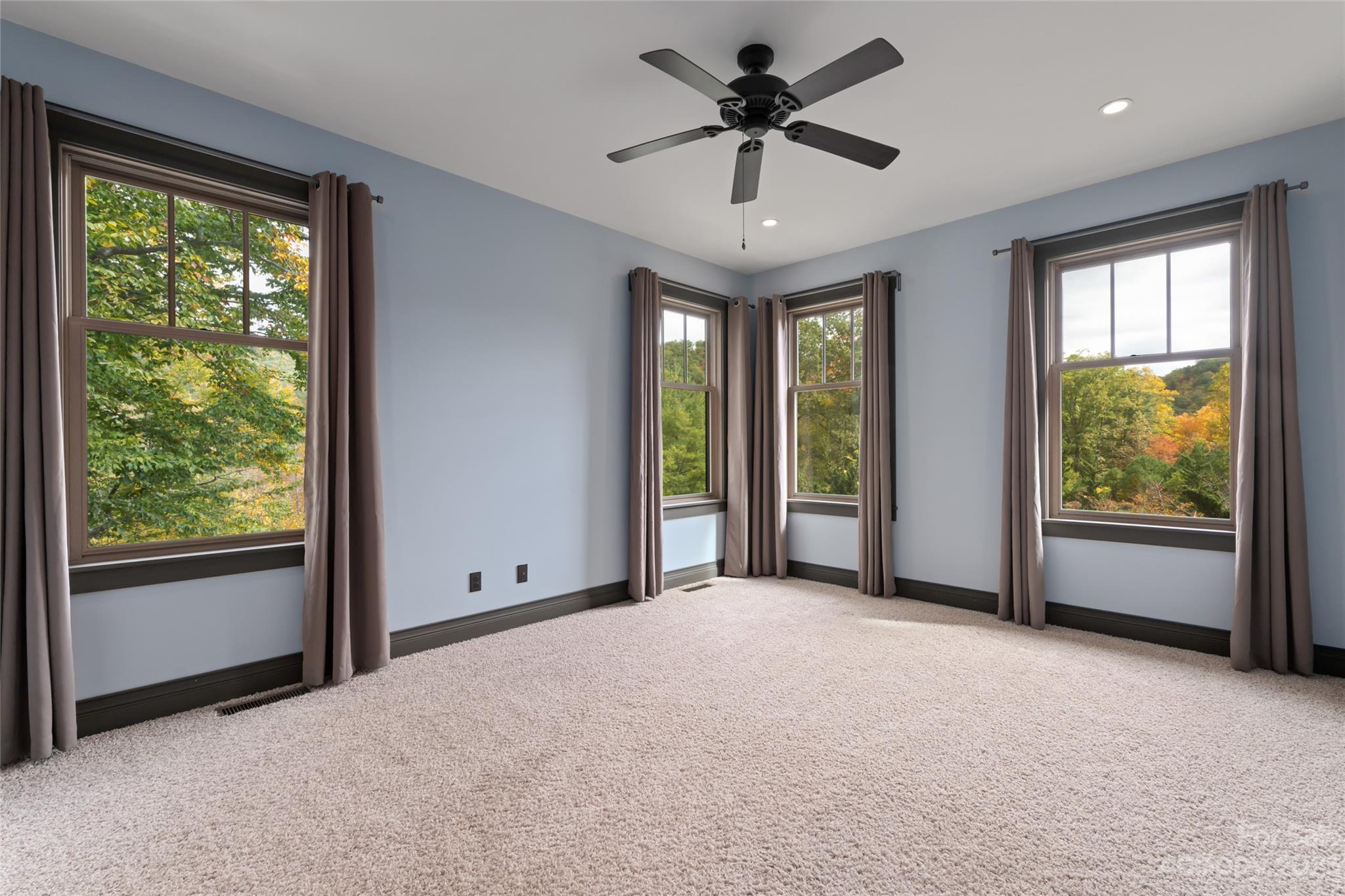 1025 Morgan Hill Road Black Mountain, NC 28711 - Photo 22 of 48 a view of a livingroom with a ceiling fan and windows