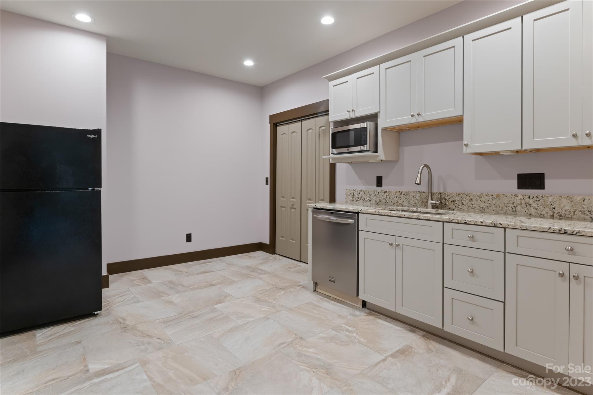1025 Morgan Hill Road Black Mountain, NC 28711 - Photo 28 of 48 a kitchen with cabinets and stainless steel appliances