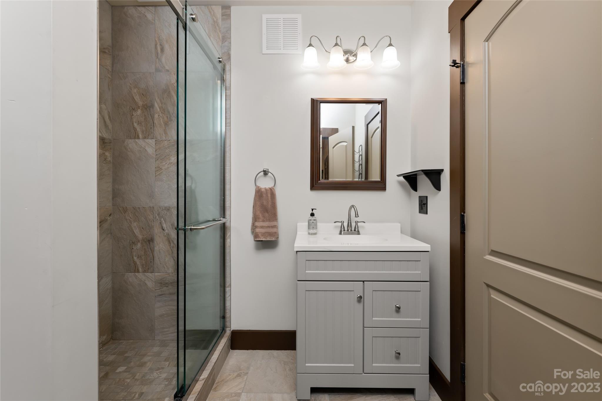 1025 Morgan Hill Road Black Mountain, NC 28711 - Photo 34 of 48 a bathroom with a sink vanity granite and a mirror