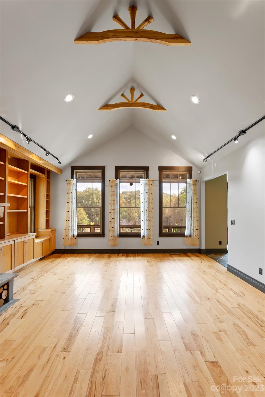 1025 Morgan Hill Road Black Mountain, NC 28711 - Photo 6 of 48 an empty room with wooden floor and windows