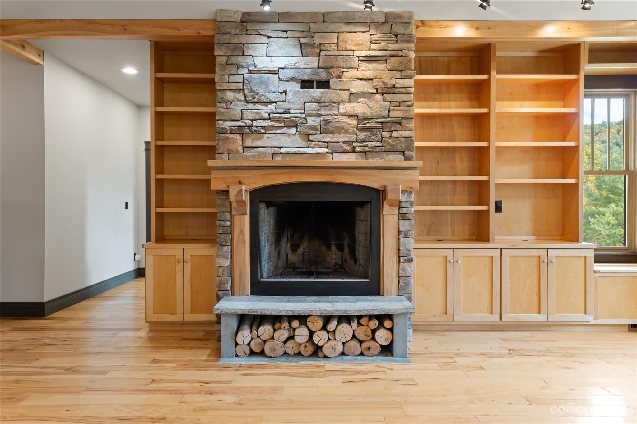 1025 Morgan Hill Road Black Mountain, NC 28711 - Photo 7 of 48 a living room with a fireplace and a wooden floor