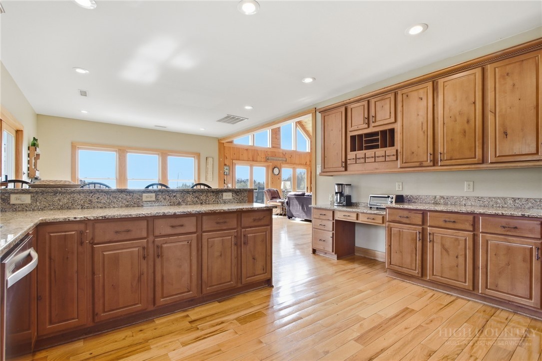 2081 Blackberry Road Boone, NC 28607 - Photo 21 of 45 a kitchen with granite countertop wooden cabinets a sink and dishwasher