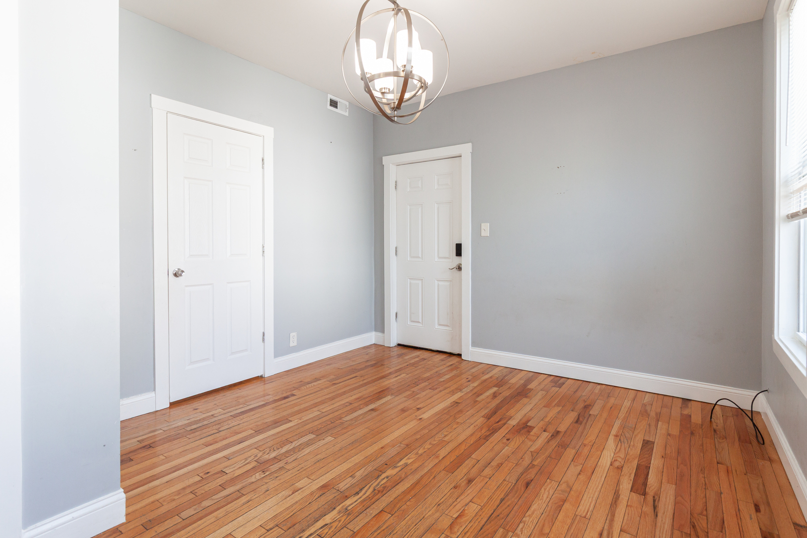 2968 North Ridgeway Avenue, Unit 2R Chicago, IL 60618 - Photo 12 of 23 a view of empty room with wooden floor