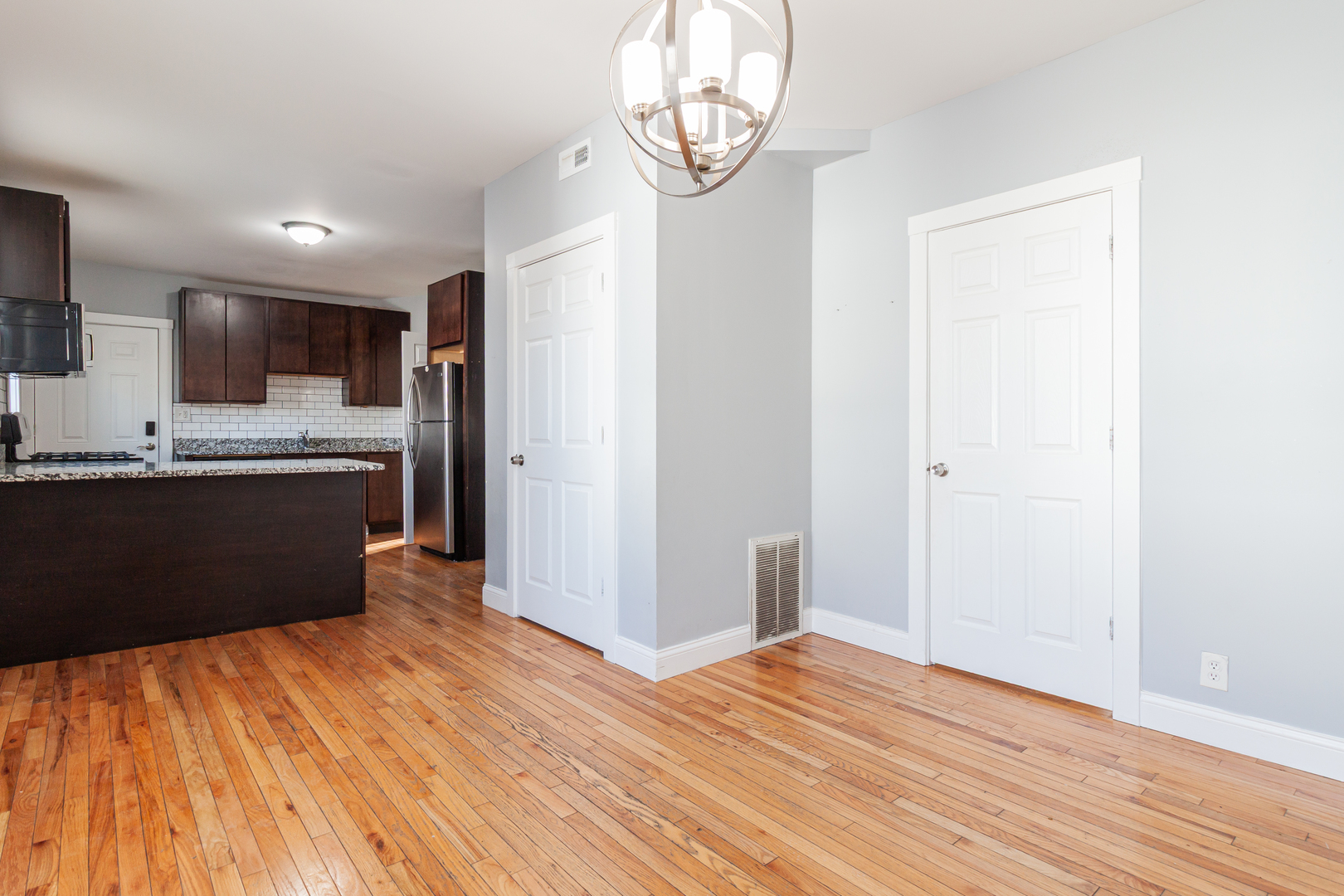 2968 North Ridgeway Avenue, Unit 2R Chicago, IL 60618 - Photo 13 of 23 a view of kitchen with wooden floor