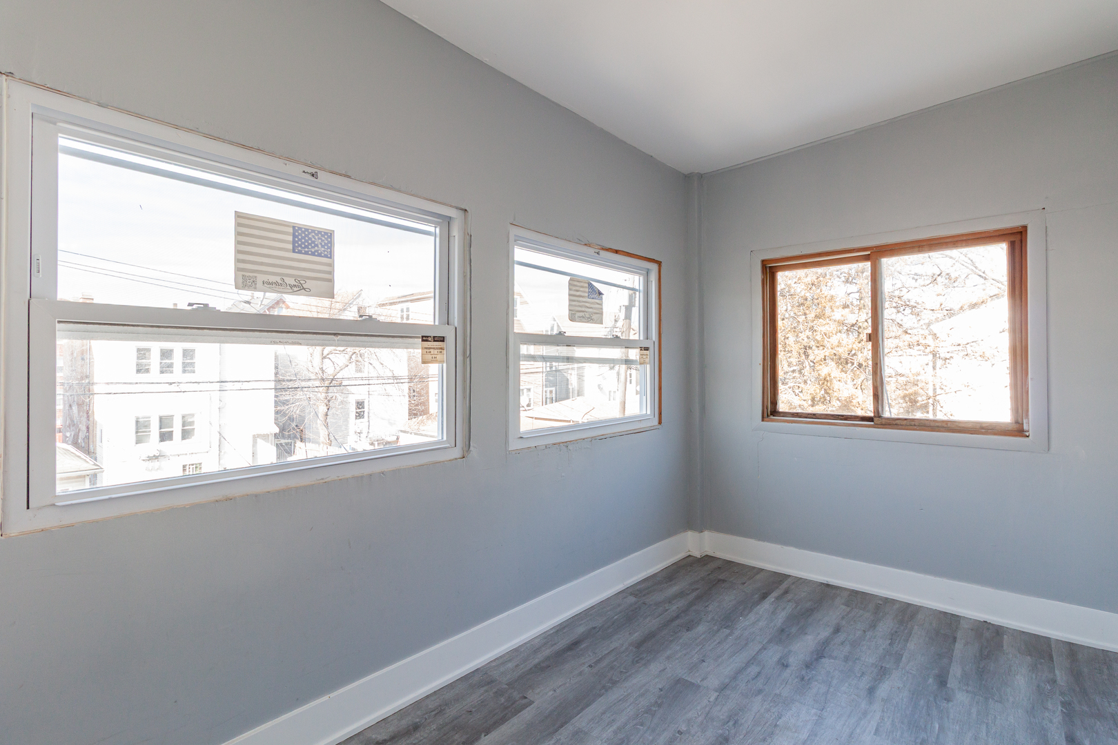 2968 North Ridgeway Avenue, Unit 2R Chicago, IL 60618 - Photo 22 of 23 a view of an empty room with wooden floor and a window