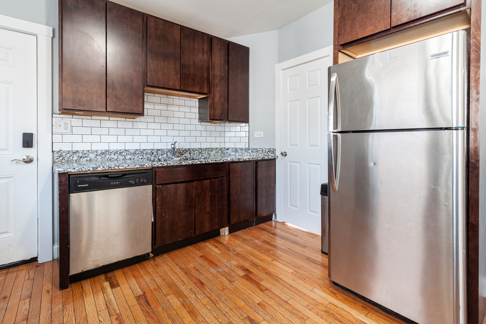 2968 North Ridgeway Avenue, Unit 2R Chicago, IL 60618 - Photo 7 of 23 a kitchen with stainless steel appliances granite countertop a refrigerator and a sink