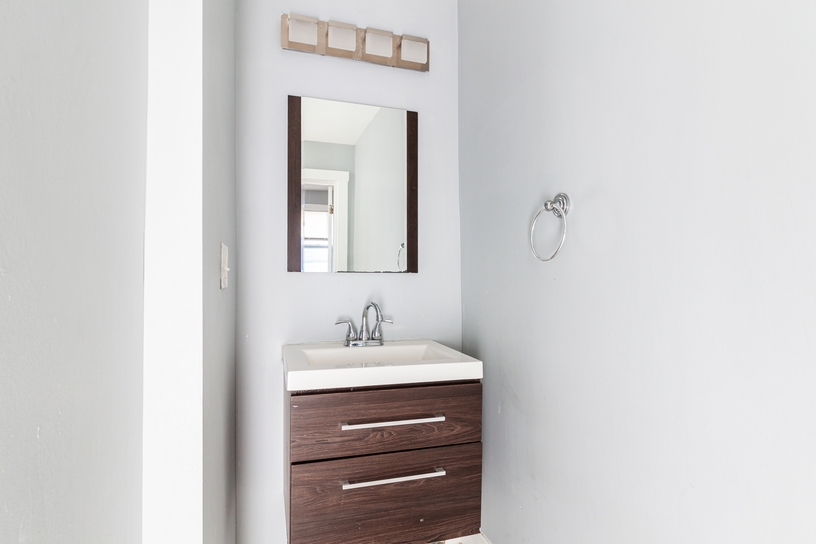 2968 North Ridgeway Avenue, Unit 2R Chicago, IL 60618 - Photo 8 of 23 a bathroom with a sink vanity and a mirror